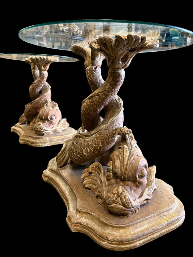 Pair of wooden coffee tables, ‘Mythological Fish,’ late 19th century. Highly decorative coffee tables depicting two intertwined fish, finely carved and featuring a round glass top.In good condition