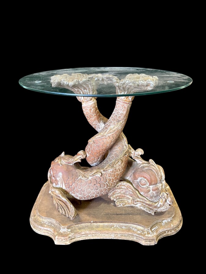 Pair of wooden coffee tables, ‘Mythological Fish,’ late 19th century. Highly decorative coffee tables depicting two intertwined fish, finely carved and featuring a round glass top.In good condition wi