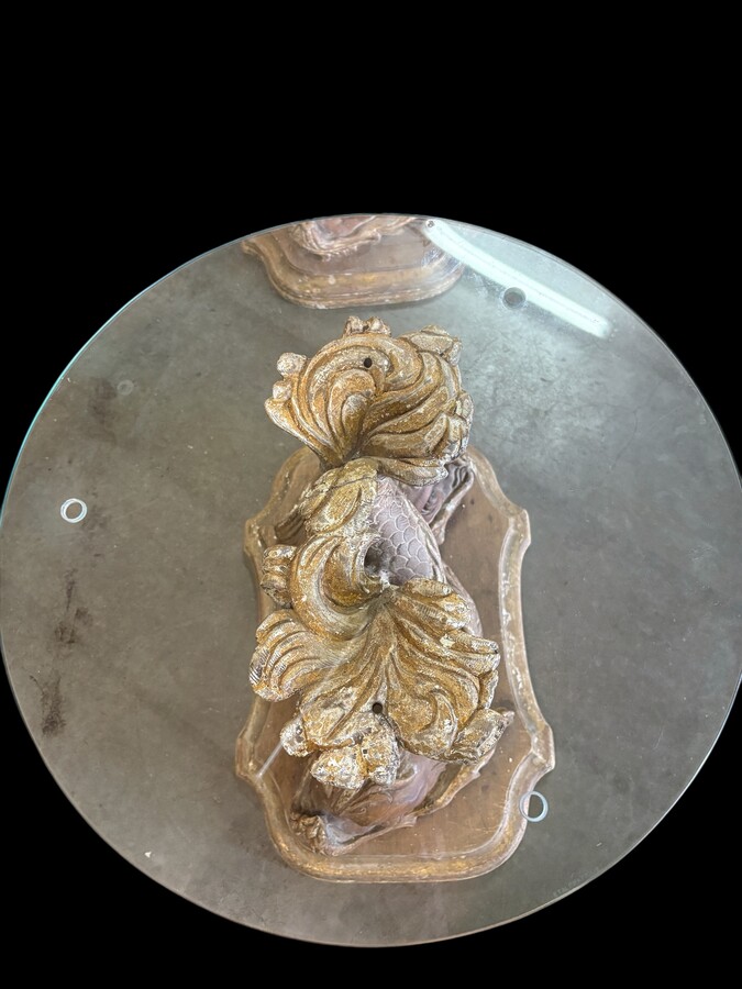 Pair of wooden coffee tables, ‘Mythological Fish,’ late 19th century. Highly decorative coffee tables depicting two intertwined fish, finely carved and featuring a round glass top.In good condition wi