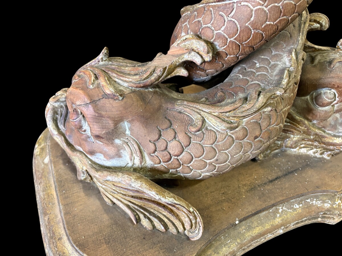 Pair of wooden coffee tables, ‘Mythological Fish,’ late 19th century. Highly decorative coffee tables depicting two intertwined fish, finely carved and featuring a round glass top.In good condition wi