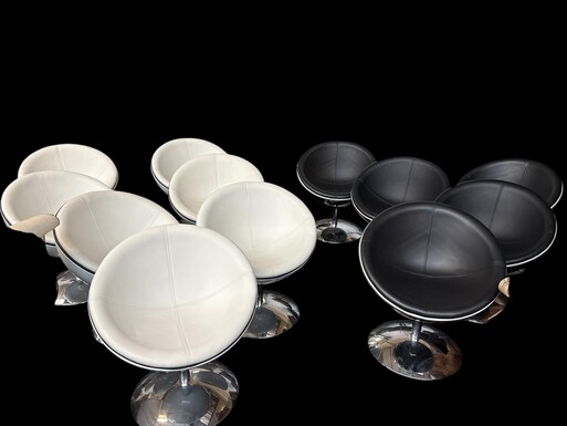Set of 12 designer chairs in a half-egg shape with coloured polyester frame, chrome metal swivel base and white and black sky upholstery. Late 20th century reproductions based on a model from the 1960s-1970s. In good condition with signs of wear.