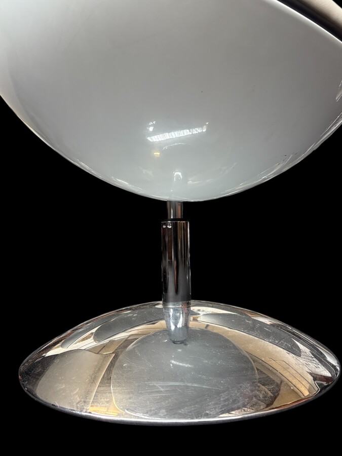 Set of 12 designer chairs in a half-egg shape with coloured polyester frame, chrome metal swivel base and white and black sky upholstery. Late 20th century reproductions based on a model from the 1960s-1970s. In good condition with signs of wear.