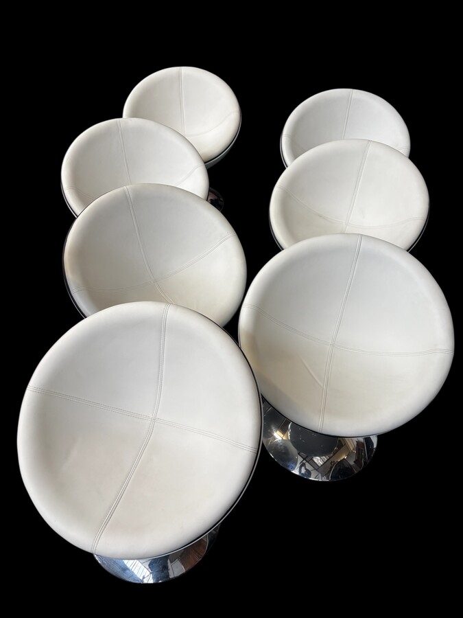 Set of 12 designer chairs in a half-egg shape with coloured polyester frame, chrome metal swivel base and white and black sky upholstery. Late 20th century reproductions based on a model from the 1960s-1970s. In good condition with signs of wear.