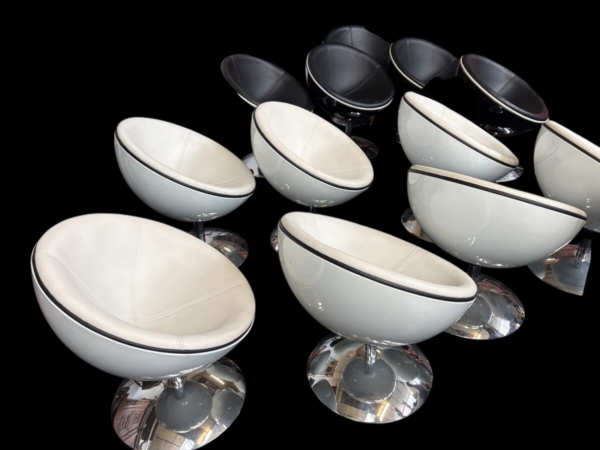 Set of 12 designer chairs in a half-egg shape with coloured polyester frame, chrome metal swivel base and white and black sky upholstery. Late 20th century reproductions based on a model from the 1960s-1970s. In good condition with signs of wear.