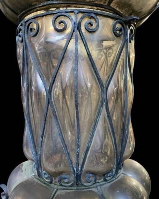 Special large outdoor lamp / lantern in wrought iron and curved glass 1930 ( 126 cm ) Very decorative lantern with curved glass in a wrought iron frame. Lantern needs a small restoration to an iron edge at the top , the glass is in very good condition.