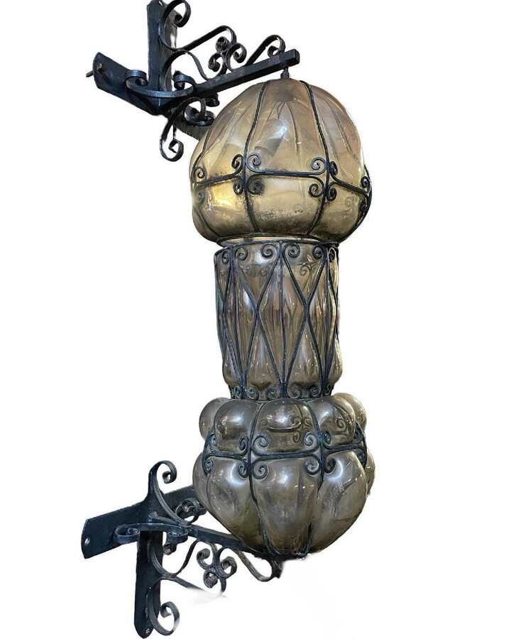 Special large outdoor lamp / lantern in wrought iron and curved glass 1930 ( 126 cm ) Very decorative lantern with curved glass in a wrought iron frame. Lantern needs a small restoration to an iron edge at the top , the glass is in very good condition.