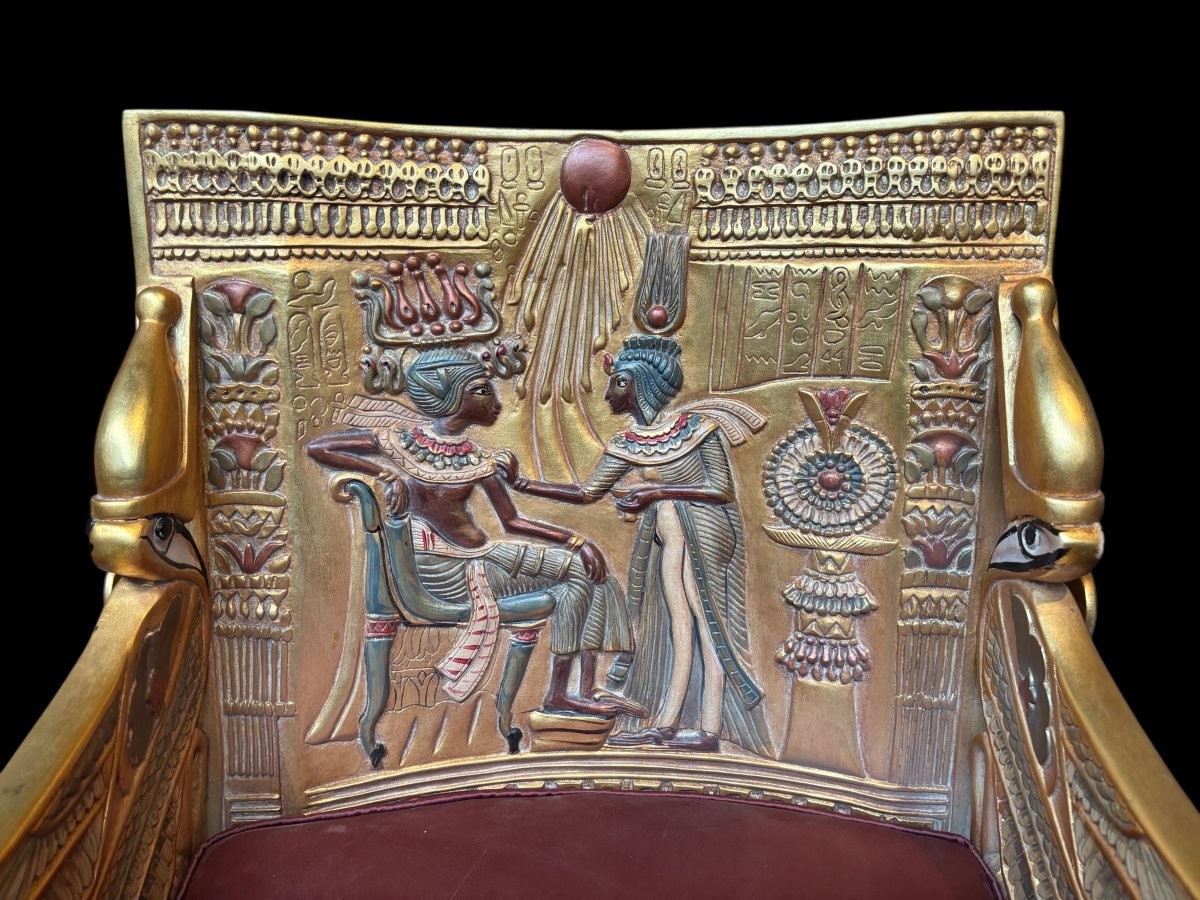 Tutankhamun throne in gilded and patinated wood 21st C. Very decorative gilded wood throne with silk fabric cushion ‘after’ The throne, from the tomb of Tutankhamun.Tutankhamun, pharaoh of ancient Egypt.