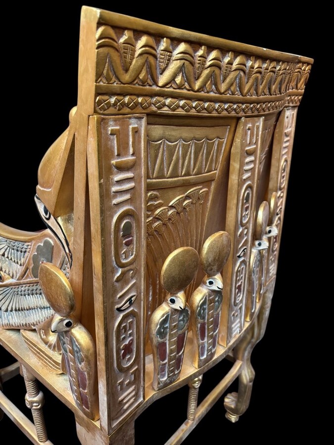 Tutankhamun throne in gilded and patinated wood 21st C. Very decorative gilded wood throne with silk fabric cushion ‘after’ The throne, from the tomb of Tutankhamun.Tutankhamun, pharaoh of ancient Egypt.