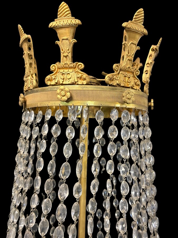 Very large Empire-style ‘pearl bag’ chandelier, circa 1900 A magnificent large ‘pearl bag’ chandelier featuring a decorated crown and border, as well as 12 gilded bronze candle holders.