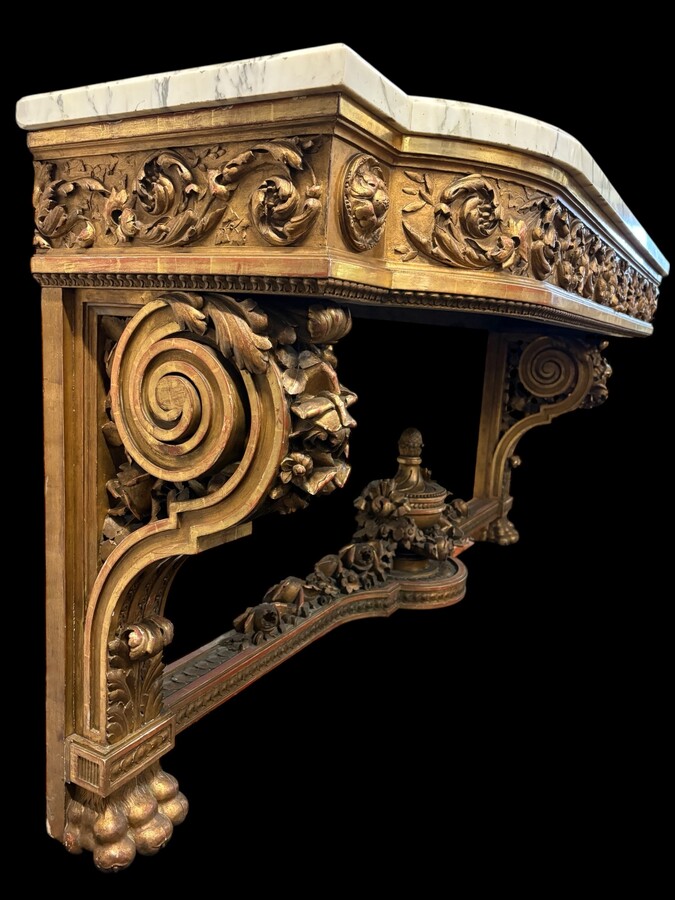 Very large Louis XVI style console table (230 cm) in gilded wood from the 19th century. High-quality console table entirely carved in wood, decorated with gilded motifs, floral scrolls, a large decorative vase in its lower section.