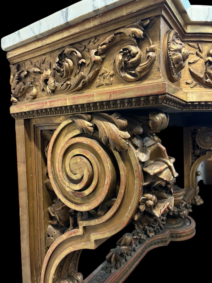 Very large Louis XVI style console table (230 cm) in gilded wood from the 19th century. High-quality console table entirely carved in wood, decorated with gilded motifs, floral scrolls, a large decorative vase in its lower section.