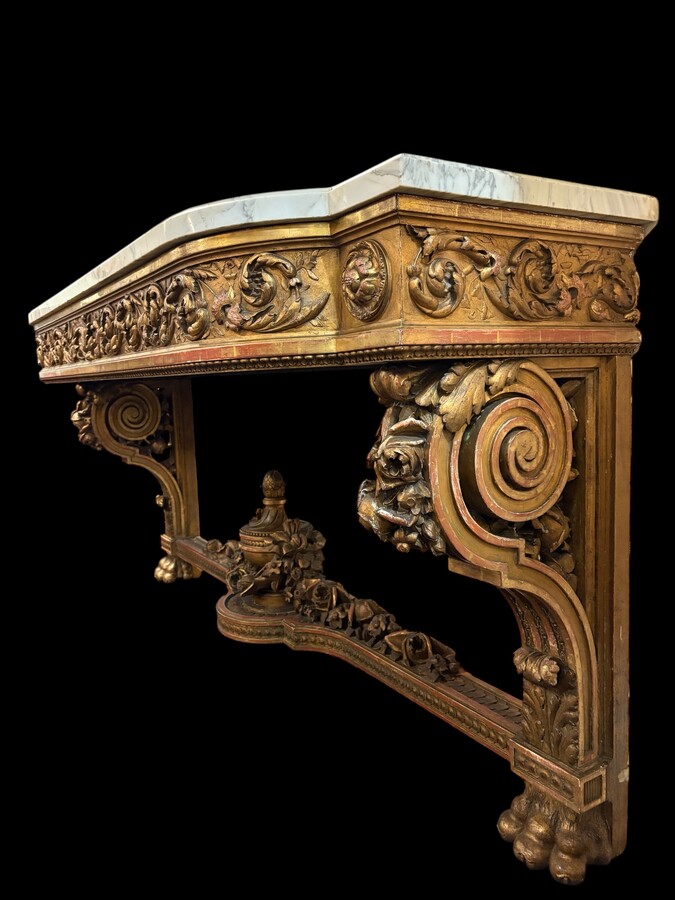 Very large Louis XVI style console table (230 cm) in gilded wood from the 19th century. High-quality console table entirely carved in wood, decorated with gilded motifs, floral scrolls, a large decorative vase in its lower section.