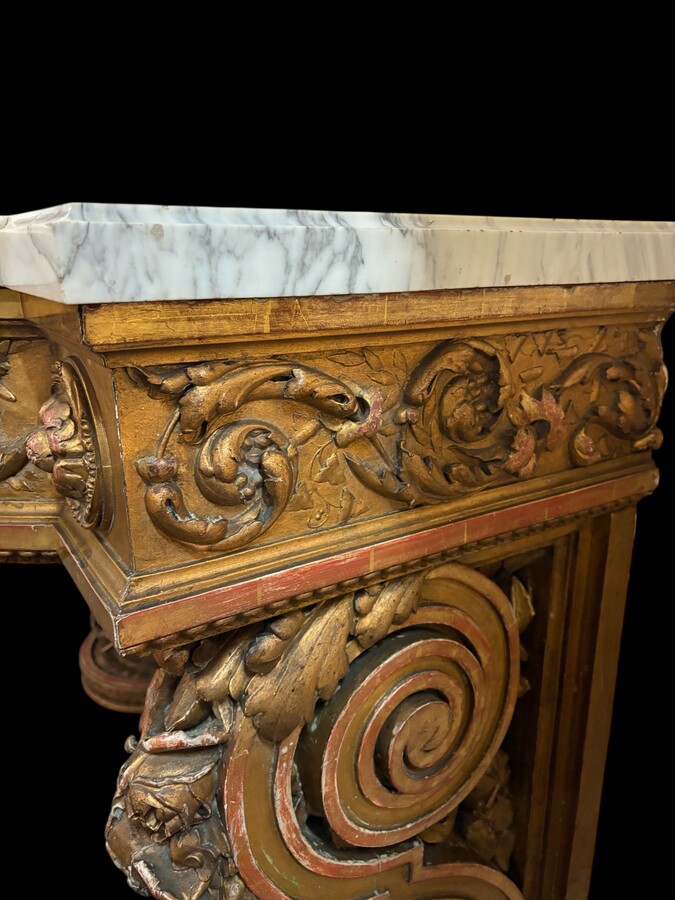 Very large Louis XVI style console table (230 cm) in gilded wood from the 19th century. High-quality console table entirely carved in wood, decorated with gilded motifs, floral scrolls, a large decorative vase in its lower section.