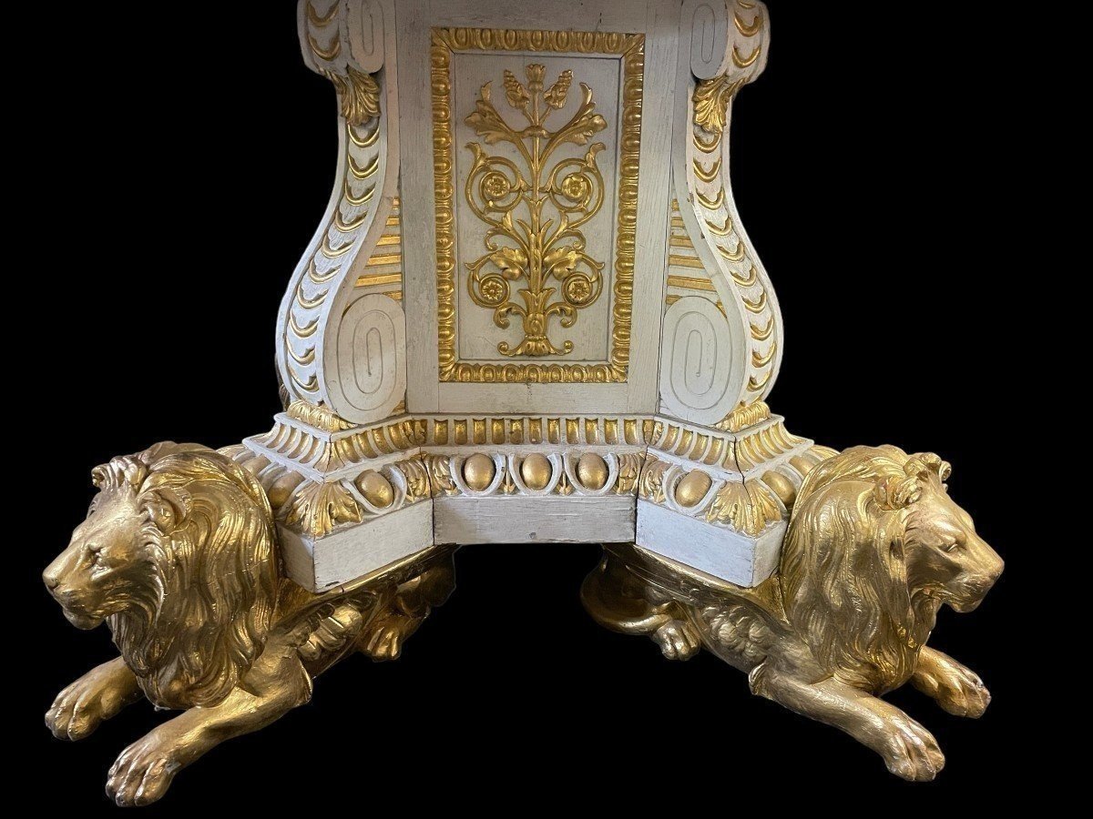 White and Gold Carved Wooden Table With Round Top In Breche d'Alep Marble. A white and gold carved wooden centre table with a round Breche d'Alep marble top resting on a central quadrangular shaft underlined by four inverted consoles and panels.