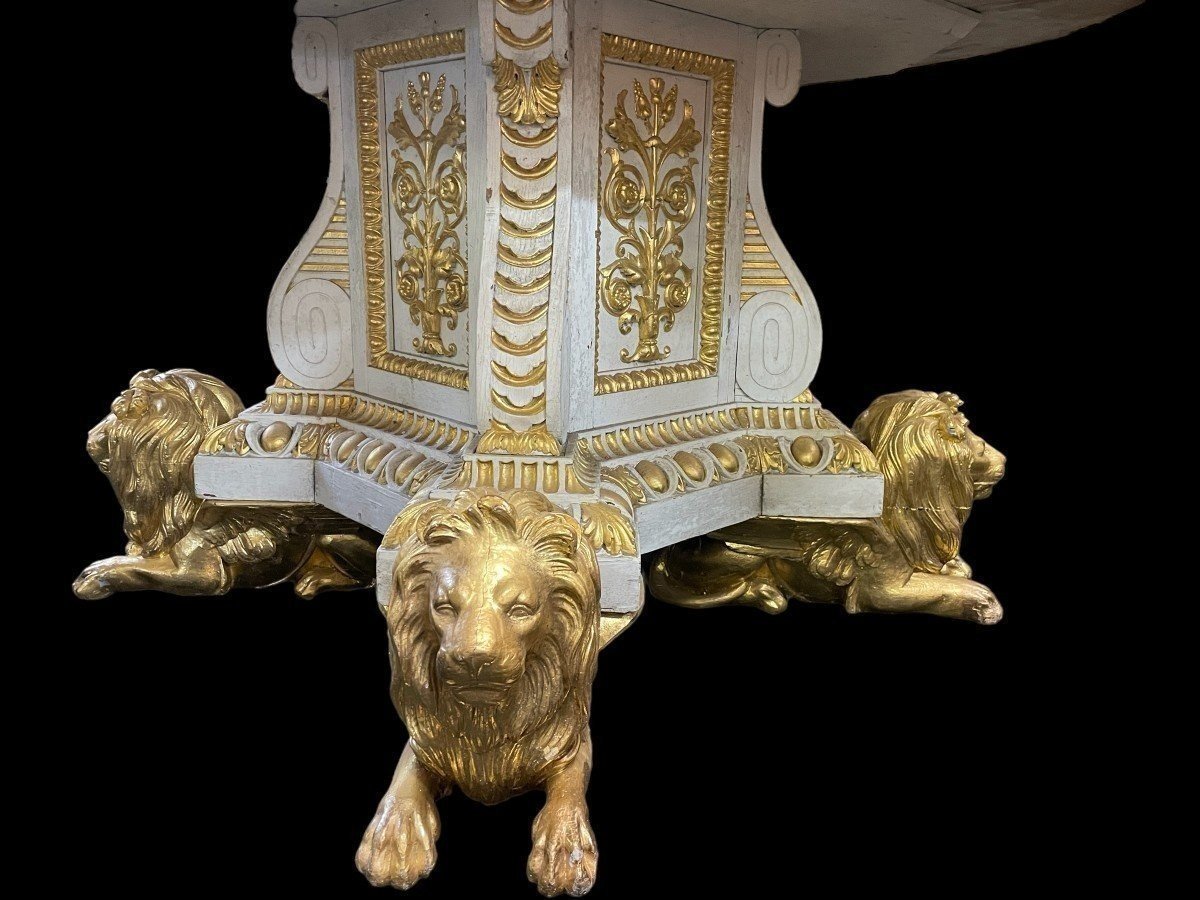 White and Gold Carved Wooden Table With Round Top In Breche d'Alep Marble. A white and gold carved wooden centre table with a round Breche d'Alep marble top resting on a central quadrangular shaft underlined by four inverted consoles and panels.